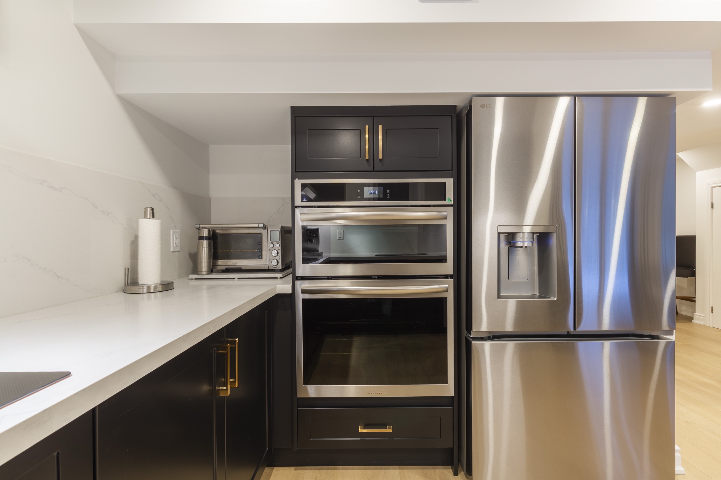 Dark framed cabinetry and warm hardware detail