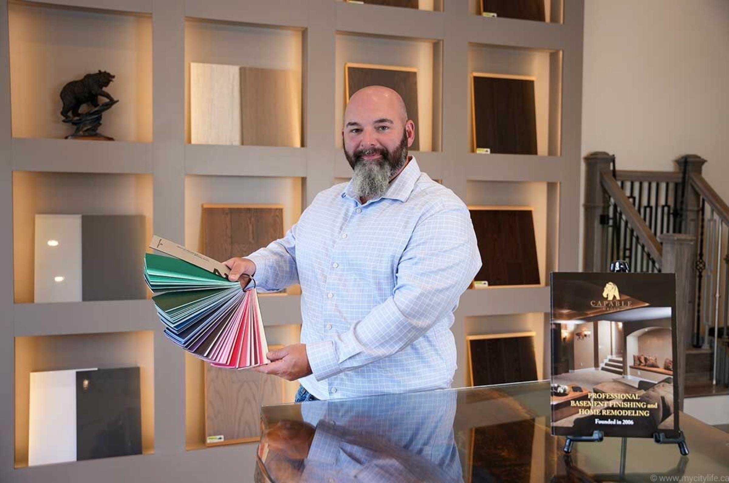 Yan in the studio with kitchen finish samples