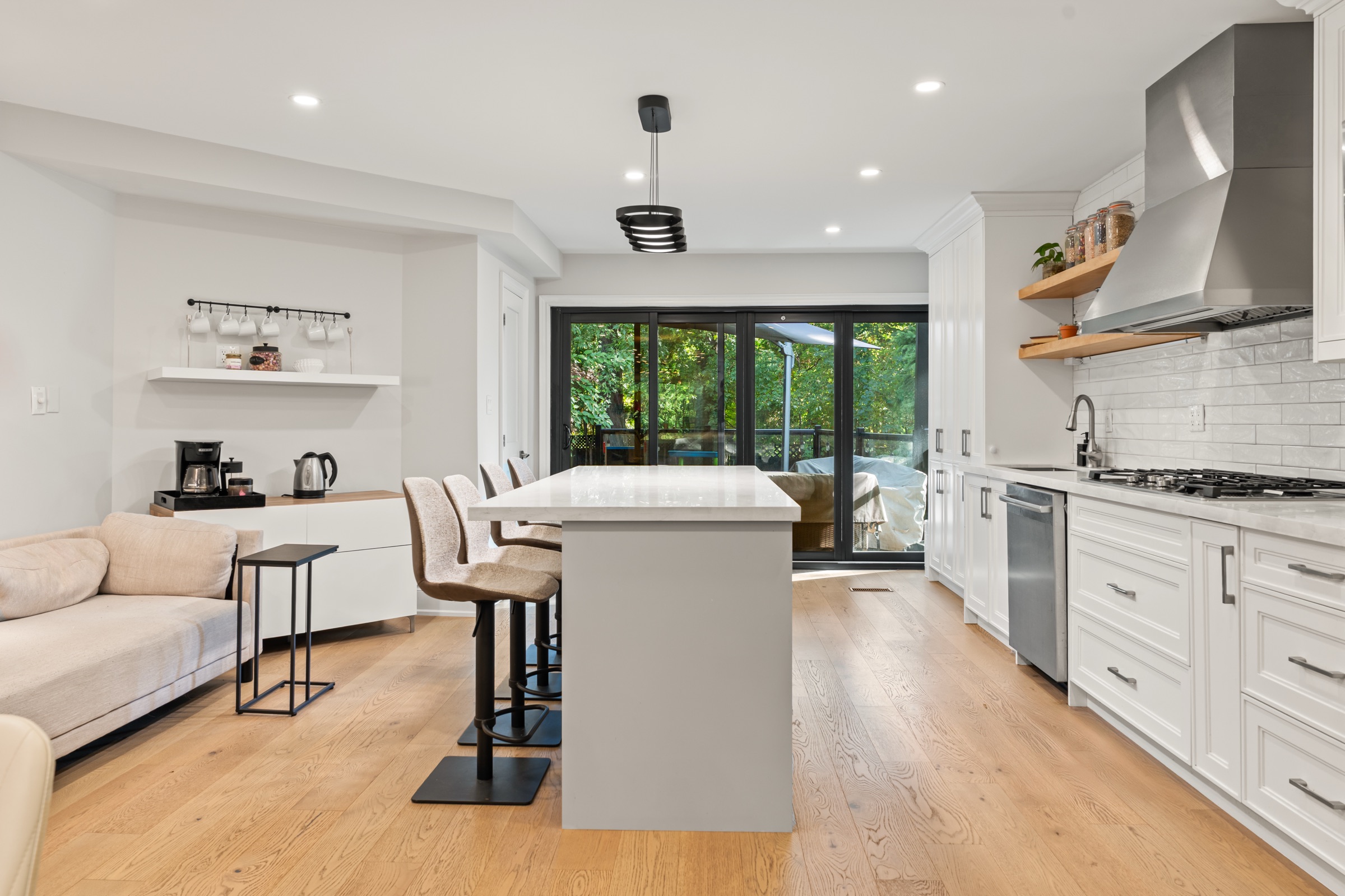 White kitchen with island seating and glazed garden doors